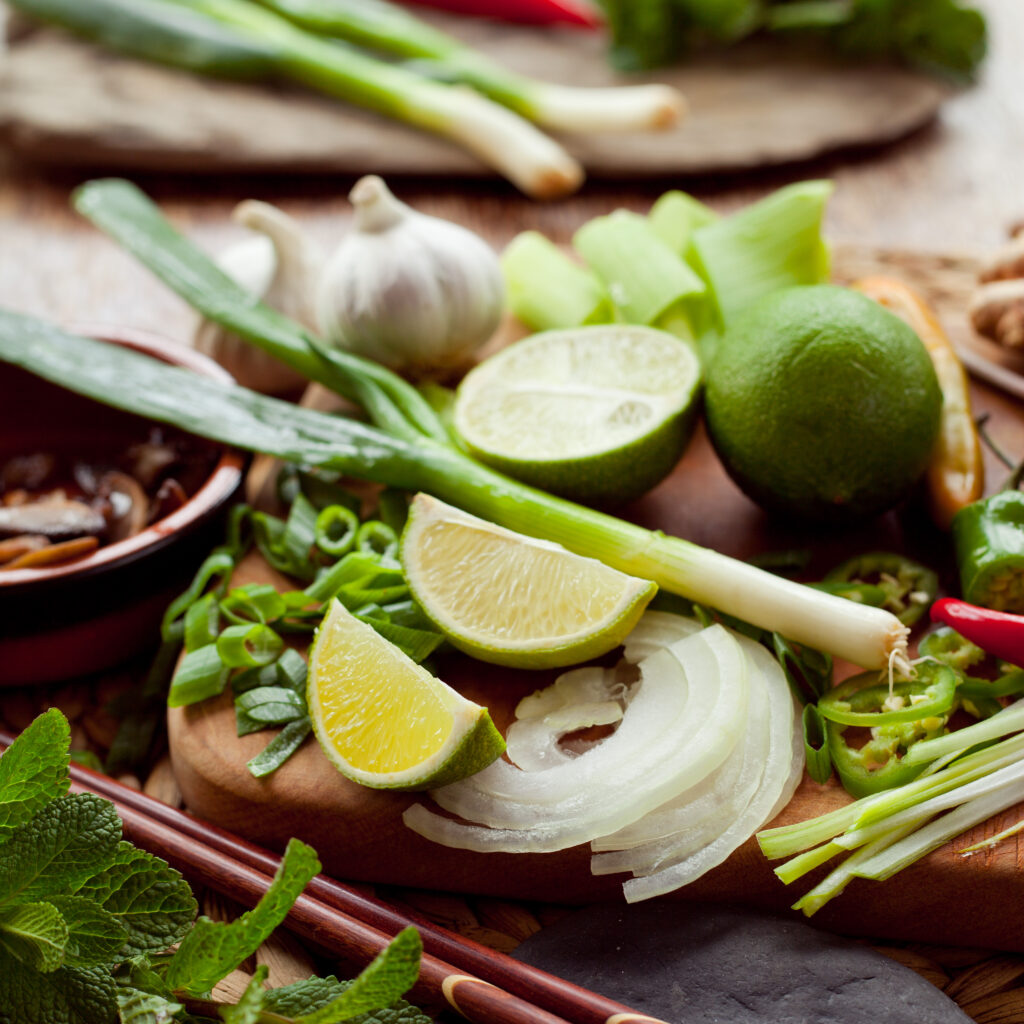 Fresh lime and herbs representing the sour side of thai-flavors in authentic Thai cuisine